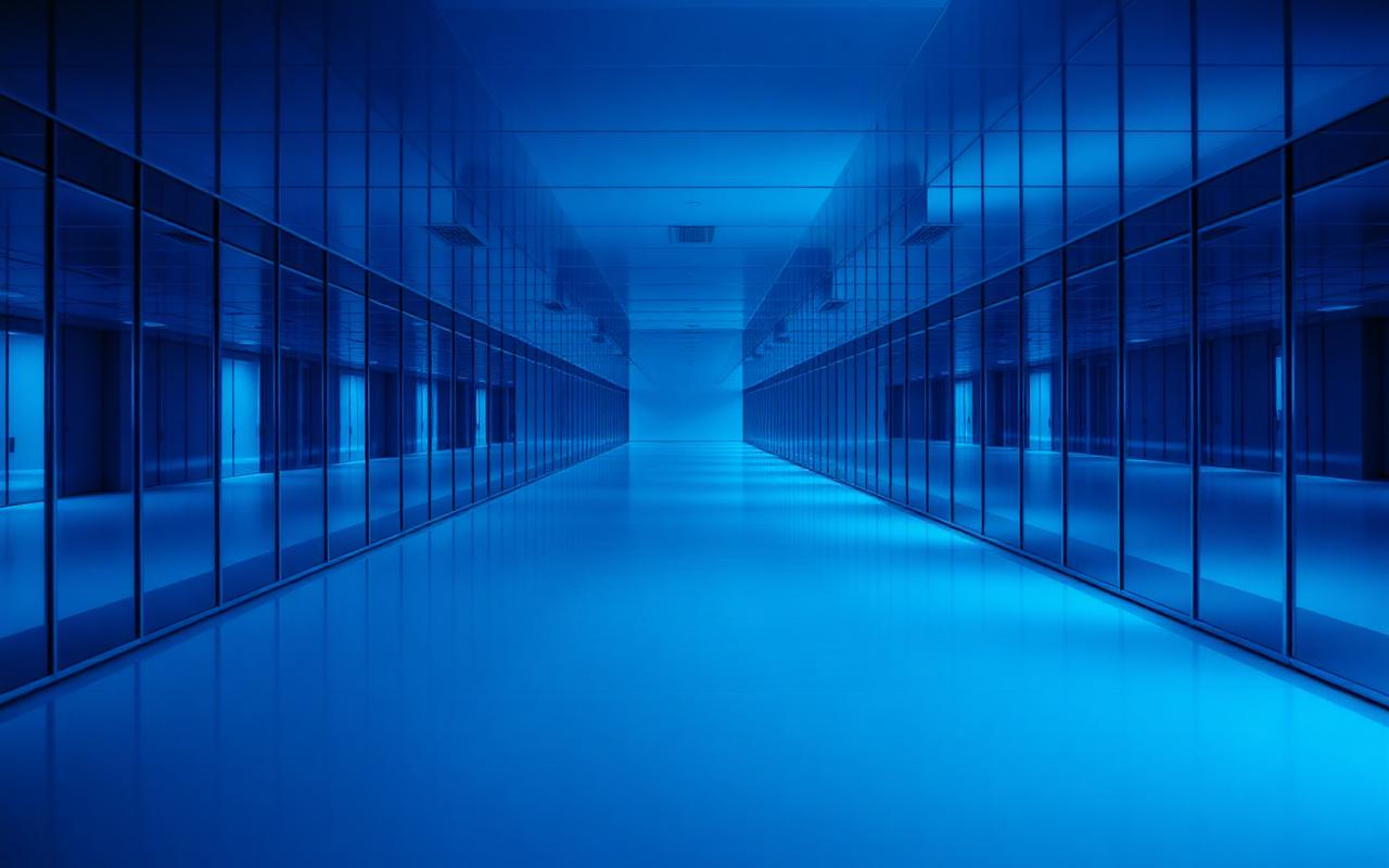 A hall of mirrors reflecting an empty room infinitely in cool blue light